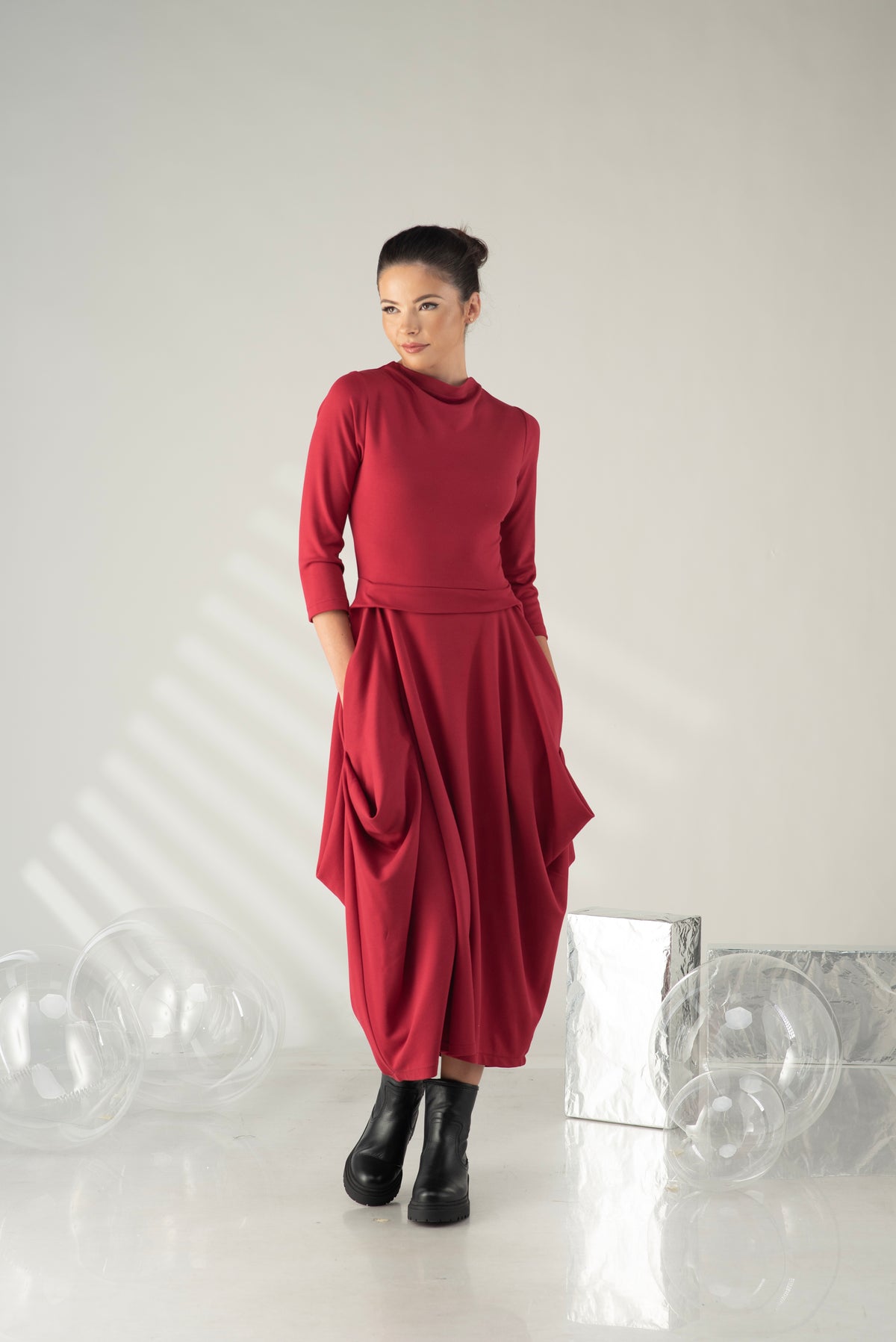 Person wearing a red outfit with a white background