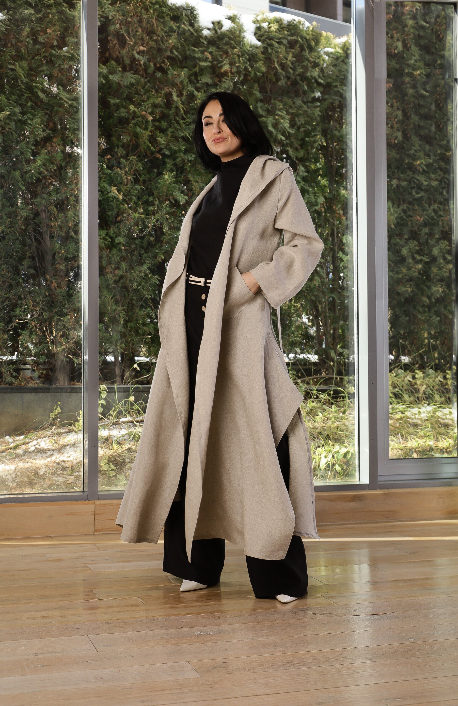 Detail view of hood and collar on beige oversized linen coat