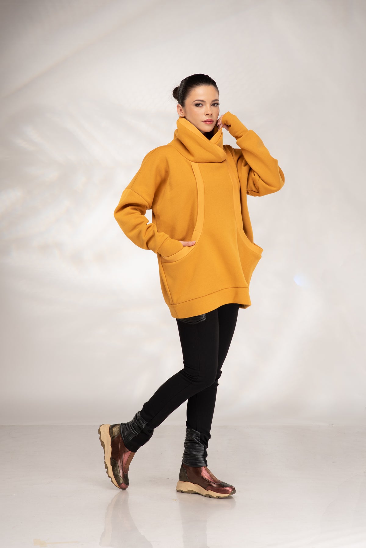 Women's mustard cowl neck hoodie with oversized fit and large front pocket, front view