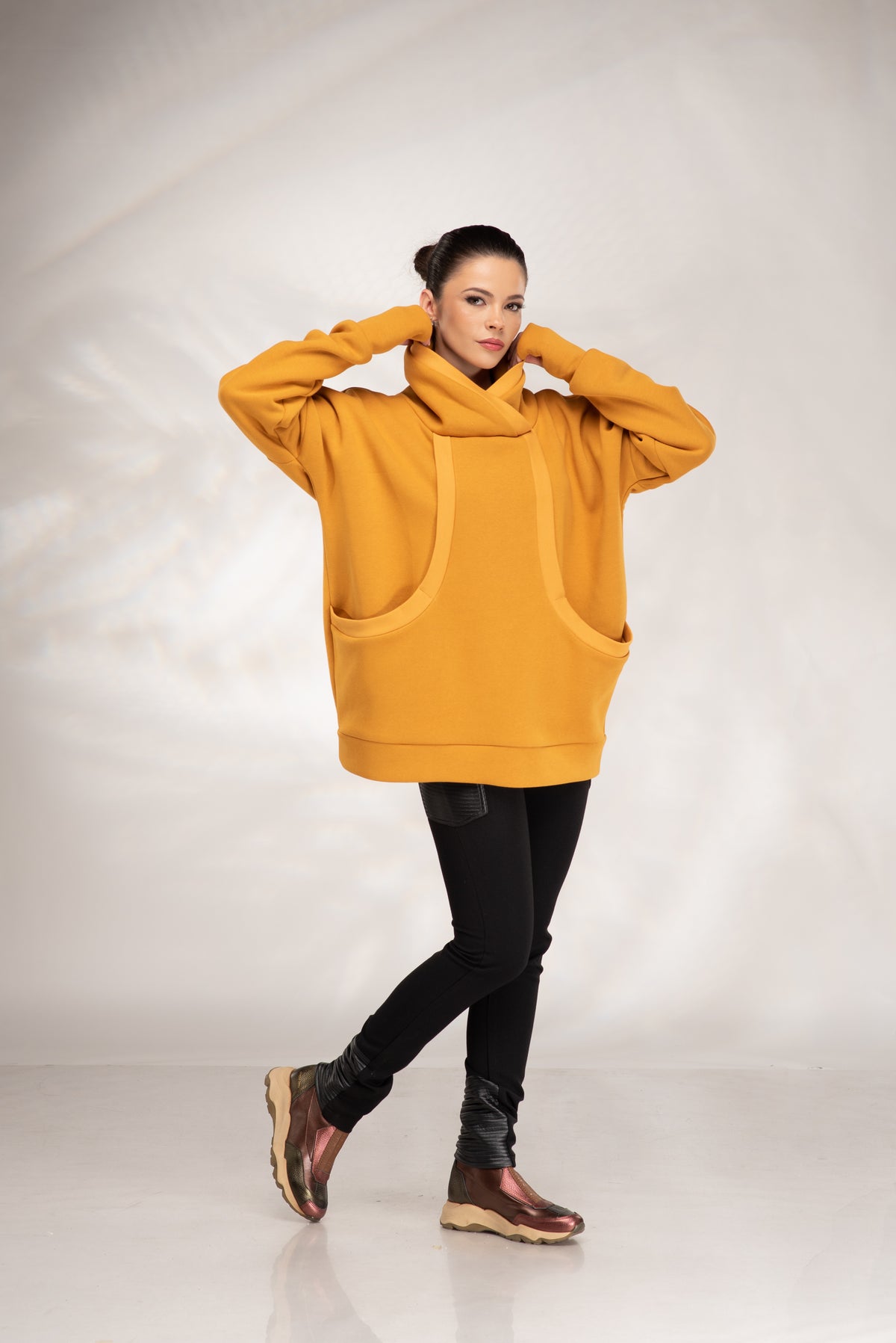 Mustard yellow oversized hoodie with crossover cowl neckline and curved front pocket