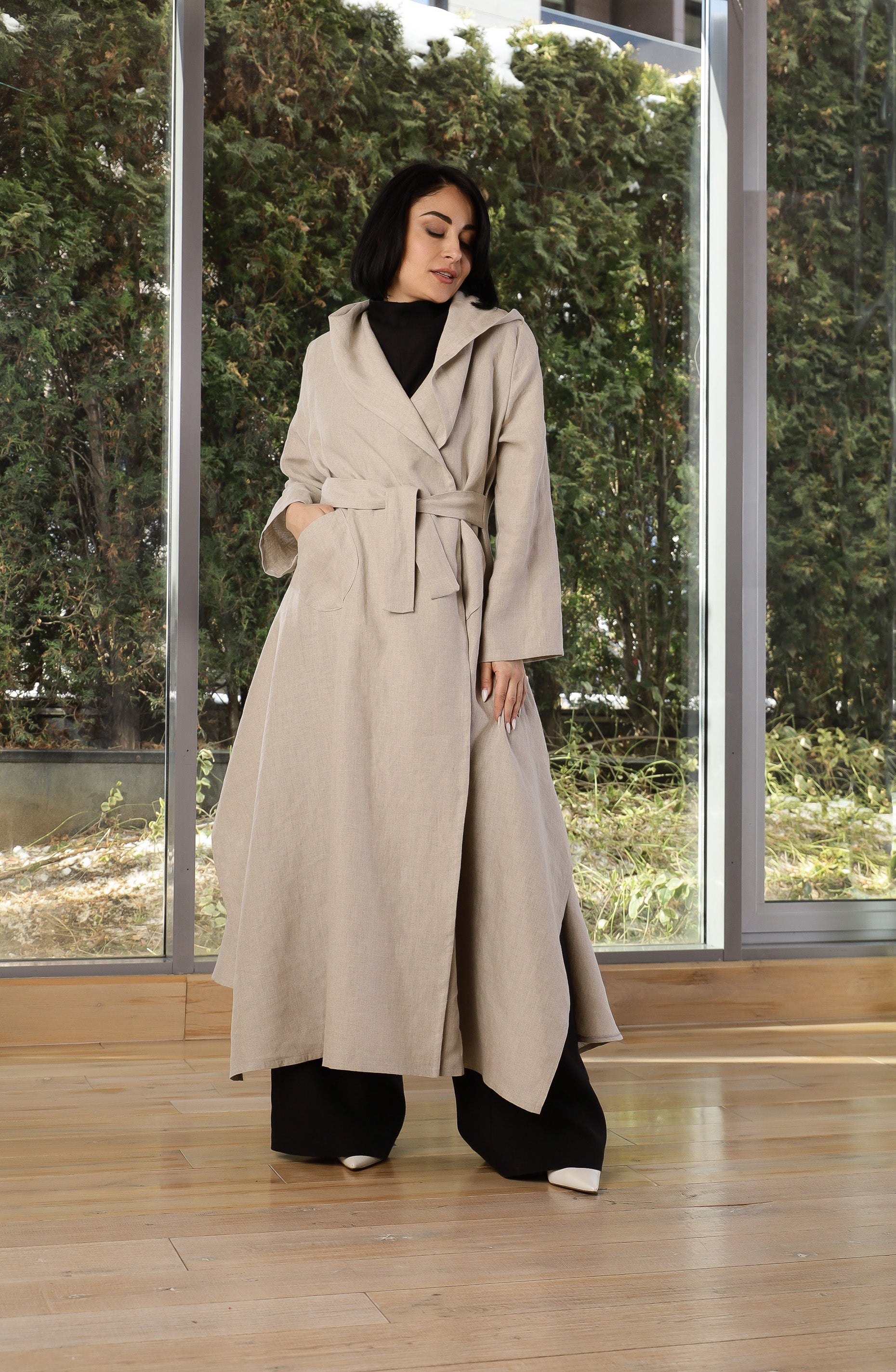 Beige linen coat styled over a minimalist outfit for spring layering