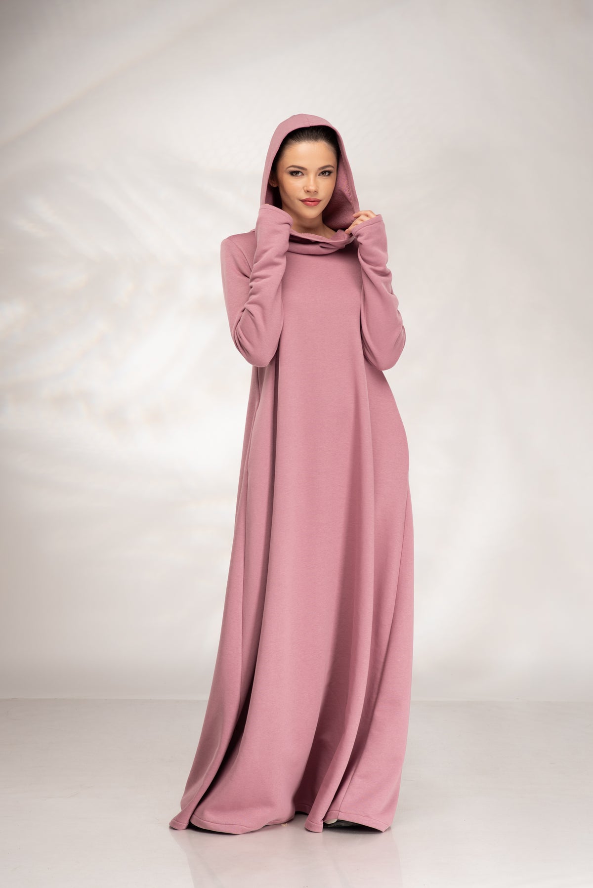 Women’s dusty pink hooded maxi sweatshirt dress, front view with hood up and thumbhole cuffs