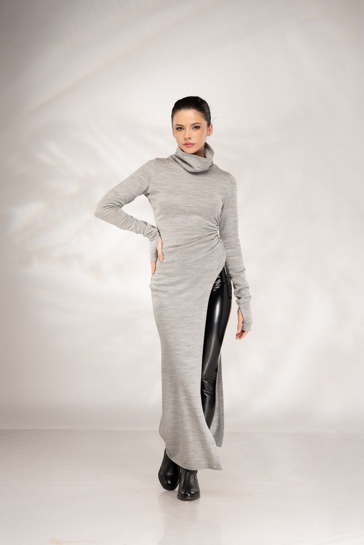 Women's grey long sleeve sweater dress with cowl neckline and figure-hugging silhouette