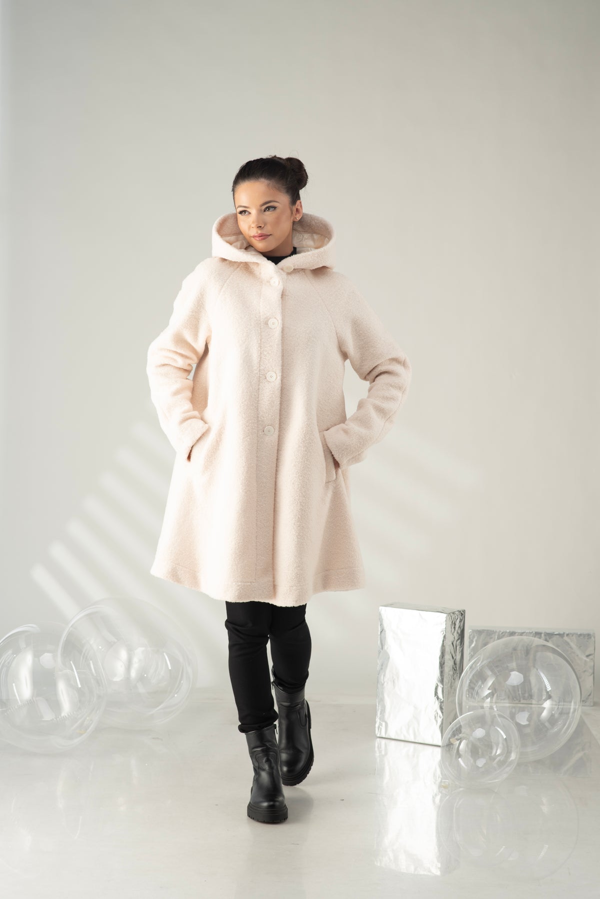 Women's hooded swing coat in a soft cream color with A-line silhouette