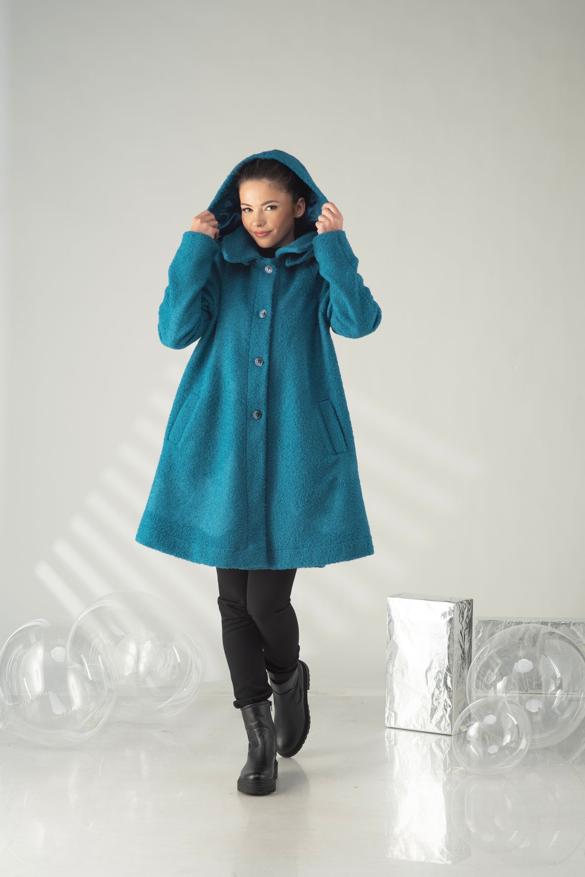 Women's teal hooded swing coat with A-line silhouette and front pockets